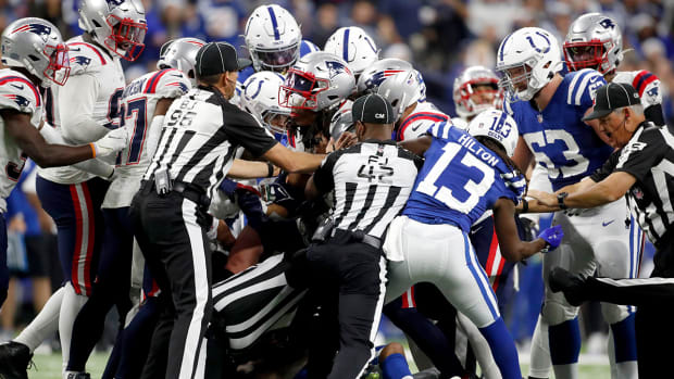 Players and referees try to break up an skirmish.
